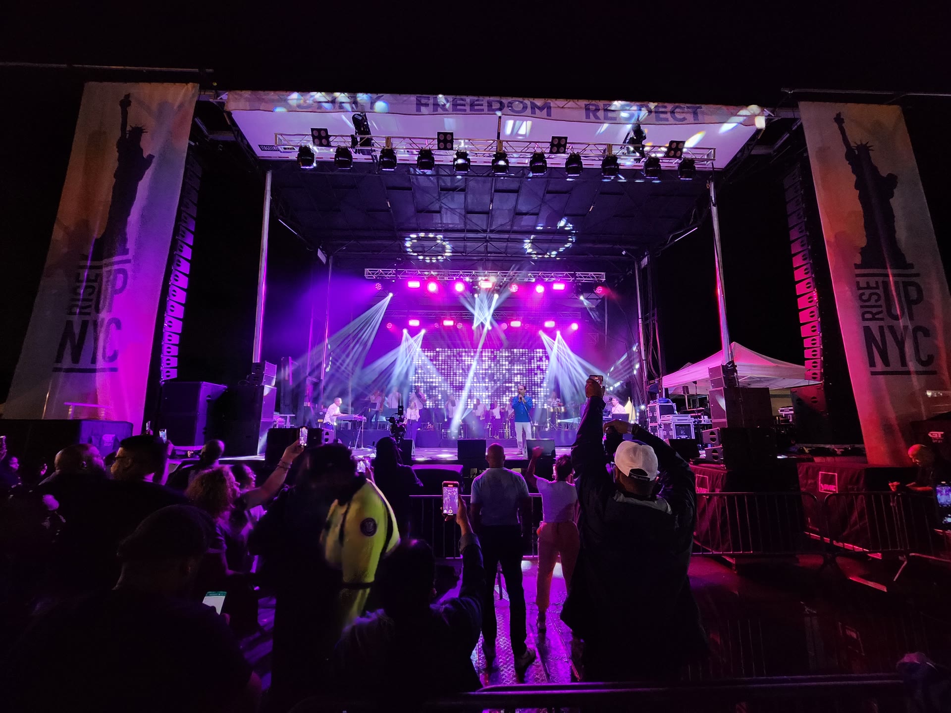 Rise Up NYC concert stage illuminated for a live audience